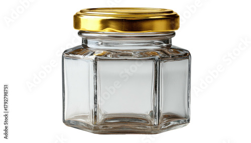 Close-up studio shot of a small, hexagonal glass jar with a shiny gold lid