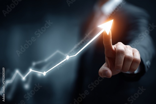 Business Professional Interacts With Upward Trend Graph in Dark Office Enviro...