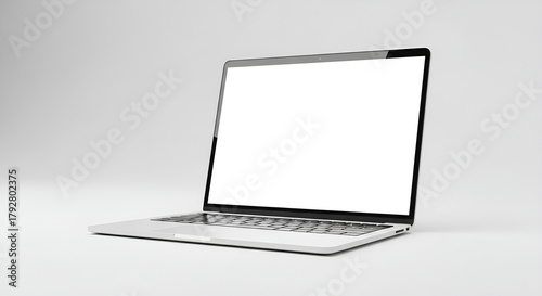 Laptop with a blank white screen displayed on a white surface in a minimalist setting studio shot