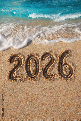 celebrate 2026 on a beach written in sand with blue ocean waves in the sunshine, top view, new years eve day, vacation, silvester, prosit, portrait format, photorealistic