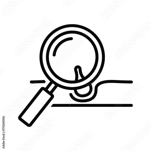 Magnifying glass examining a pore or skin imperfection on a