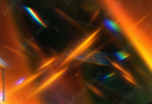 Abstract close up of shimmering orange light streaks and iridescent reflections across a dark textured backdrop, creating a warm, energetic composition for creative projects