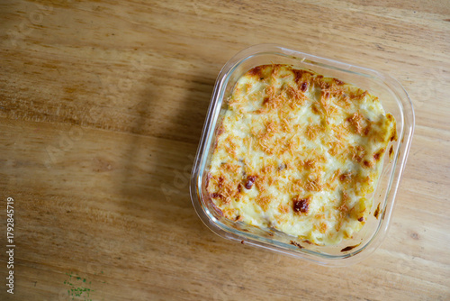Delicious baked pasta dish in a clear glass container.