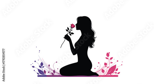 A beautiful silhouette of a woman kneeling and smelling a rose with colorful splashes.