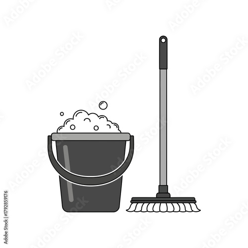 A dark gray bucket filled with soapy water and bubbles next to a mop