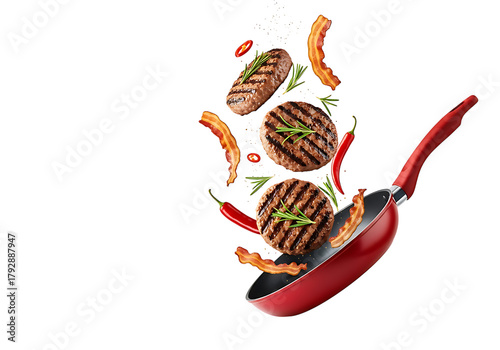 Delicious grilled burger patties and sausages flying out of a red frying pan isolated on transparent background