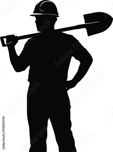 Silhouette of a construction worker wearing a hard hat and carrying a shovel over his shoulder