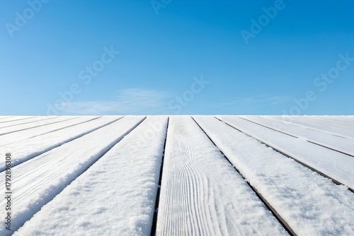 Ultra realistic white painted wood planks with snow dusting against a clear blue sky