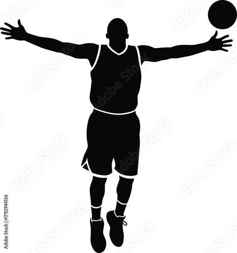 Silhouette of a basketball player in mid air during a game