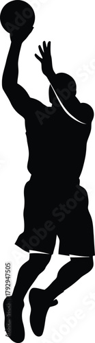 Basketball player silhouette in mid air shooting ball