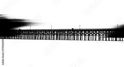 Silhouette of a long wooden pier stretching into the distance under a cloudy sky landscape view