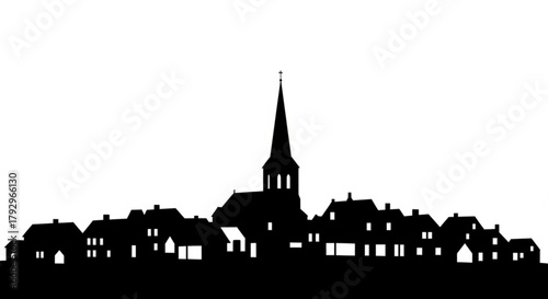 Silhouette of a european town with a church steeple rising above the buildings and houses landscape