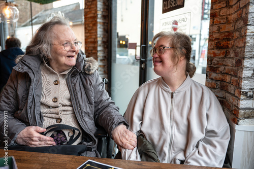 Indoor portrait of a 43-year-old woman with Down syndrome, smiling and expressing authentic joy.