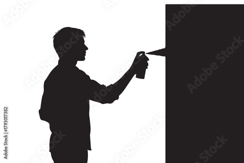 Silhouette of a person spraying paint on a wall spray paint