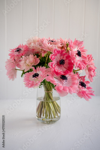 Pink anemones bouquet in clear glass vase creating floral beauty