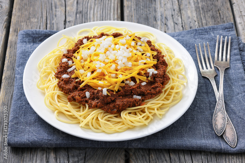 Cincinnati chili with spaghetti on white plate