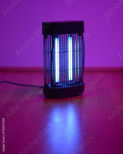 Tableau sur toile Electric insect killer lamp glowing in purple light