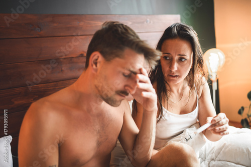 Love couple having pregnant couple problem on bed showing the test