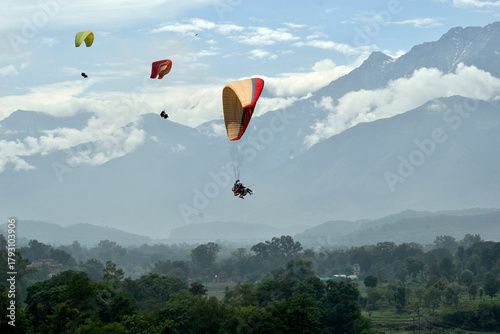 Paragliding over the clouds at Bir Billing Himachal Pradesh India. Clouds in the sky, Dhauladhar peaks view