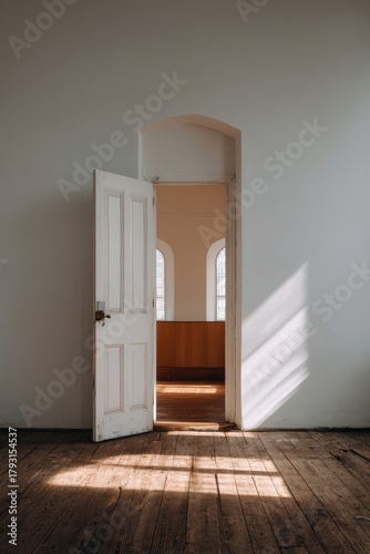 open church door welcomes visitors with warm inviting light spilling from within