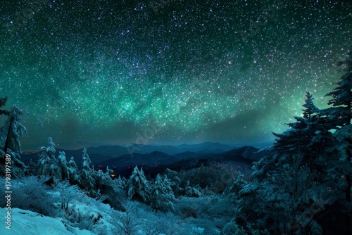 Brilliant starry night sky glows above a snowy mountain forest landscape