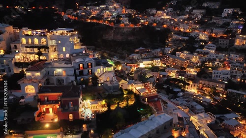 Aerial night view overlooking illuminated houses and buildings of beautiful Positano Italy on the Amalfi Coast