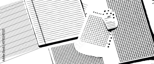 Scattered sheets of paper with lines and grids creating a chaotic yet organized monochrome pattern.
