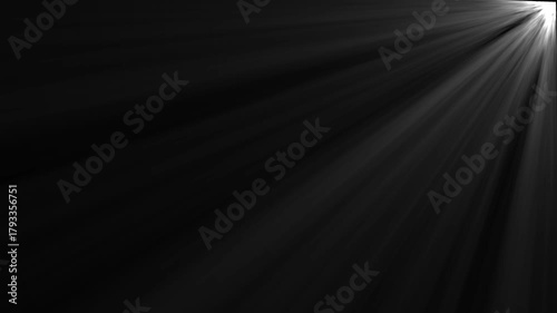 Dramatic light rays emanating from top right corner black background abstract background effect