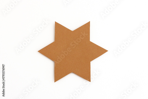 Blank star shape cut from brown cardboard isolated on white background