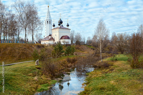 An autumn view of the Church of the Resurrection of Christ in the village of Vyatskoye. The beautiful church is set against the backdrop of a small river.