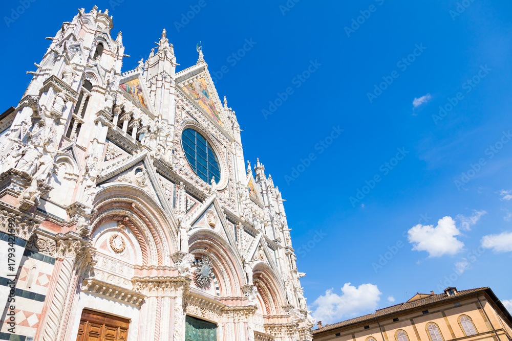 Obraz premium Siena cathedral in Italy. White marbles with blue sky, famous landmark of Tuscany.