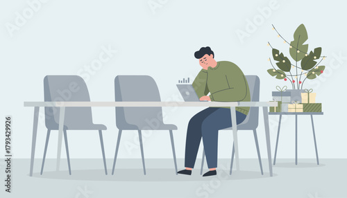 Tired man working on a laptop in a festive office illustrating holiday burnout and work stress
