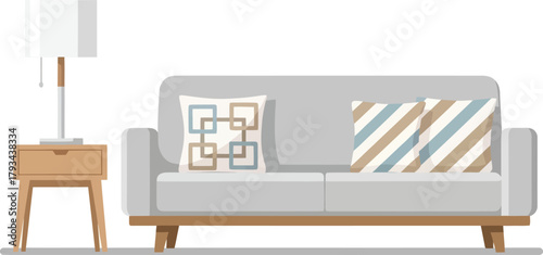 Stylish modern living room setup featuring a comfortable grey sofa with decorative pillows and a sleek wooden nightstand with a lamp, perfect for interior design inspiration.