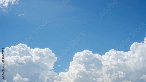 Clear blue sky with fluffy white clouds.