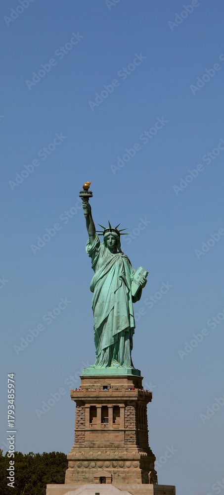 Fototapeta premium statue of liberty symbol of freedom and american democracy in new york city vertical with customizable space above