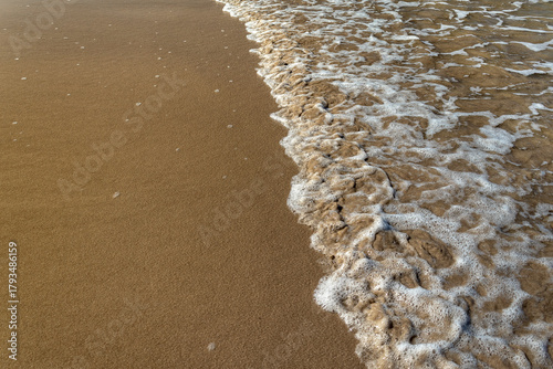 Ocean Wave Washing Over Sand Beach