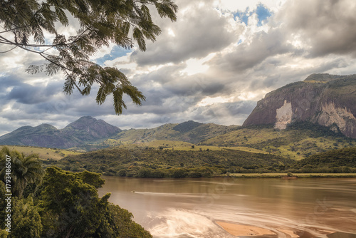 Mountain landscape with river under dramatic cloudy sky