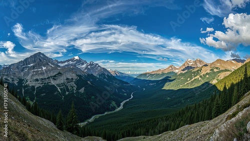 Wallpaper Mural Scenic mountain valley view with snow-capped peaks, lush green forests, and cloudy sky. Torontodigital.ca
