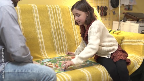 Happy father and child playing board game at home - happiness and family concept.
