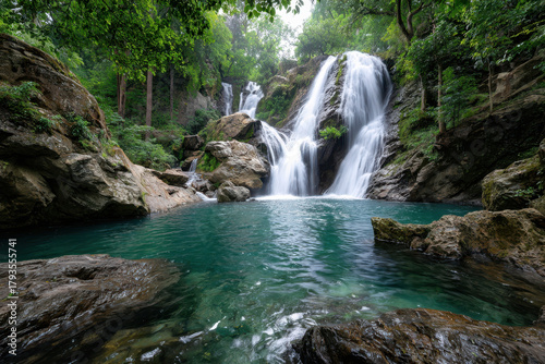 Serene Waterfall Cascades into a Tranquil Green Pool