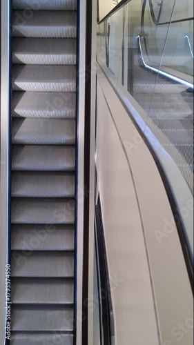 Empty escalator steps moving up in a modern building