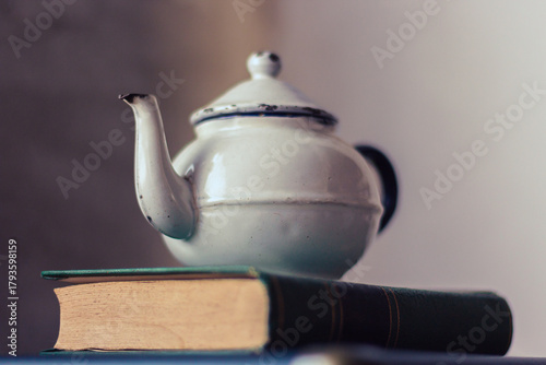 Vintage teapot on top of old books