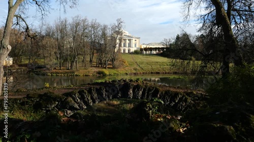 Pavlovsk Palace at top of green slope from the side of Apollo colonnade on an autumn day, 18th-century Russian Imperial residence, suburb of St. Petersburg, Russia