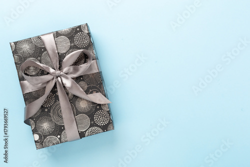 Stylish grey gift box on color background, top view
