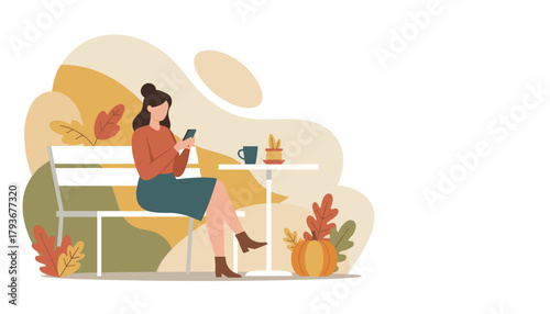 Woman relaxing outdoors in autumn sitting on a bench and using her mobile phone