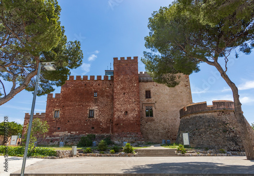 Exterior view of Castelldefels Castle, a 10th-century fortress on a sunny summer day