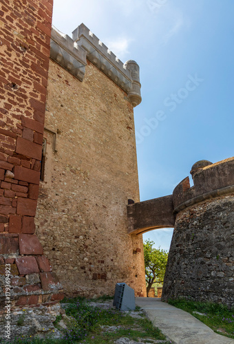 Exterior view of Castelldefels Castle, a 10th-century fortress on a sunny summer day