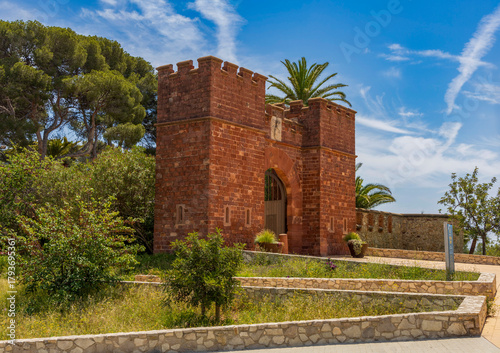 Exterior view of Castelldefels Castle, a 10th-century fortress on a sunny summer day