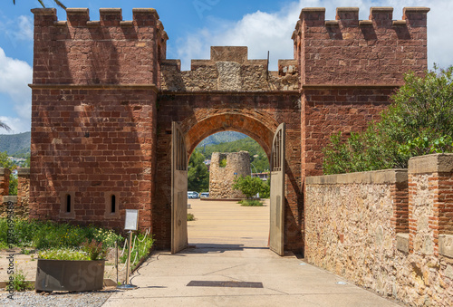 Exterior view of Castelldefels Castle, a 10th-century fortress on a sunny summer day