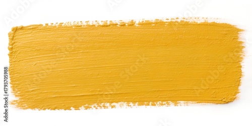 Vibrant ochre paint stroke on white canvas adding a splash of color, ideal for backgrounds and creative designs, inject warmth and energy into your projects